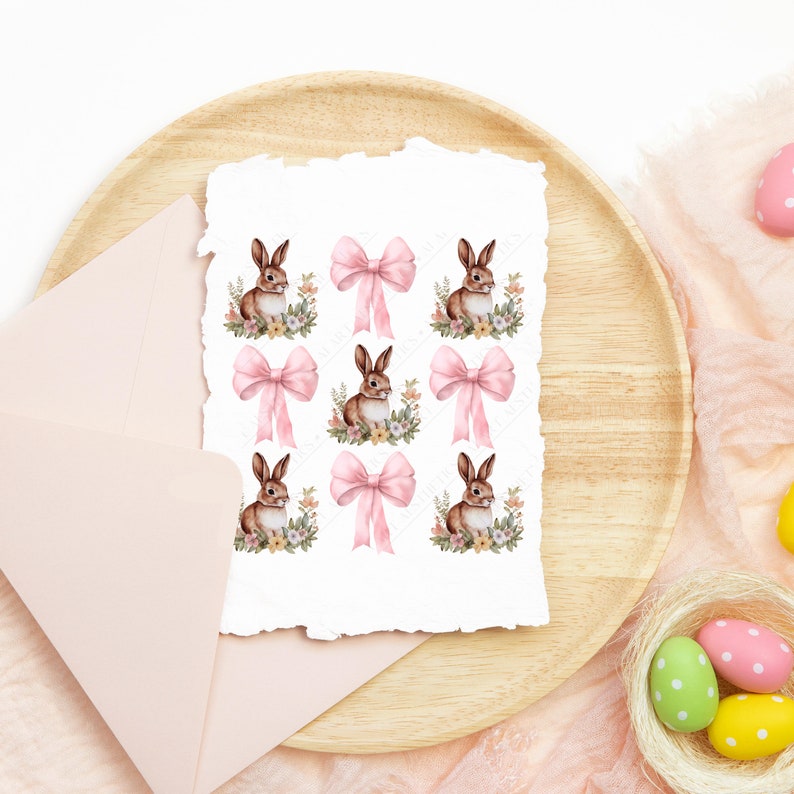 May include: A sheet of paper with nine illustrations of brown rabbits wearing pink bows. Each rabbit is surrounded by a floral design.