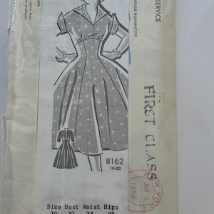 May include: Vintage sewing pattern size 14, featuring a dress illustration with a fitted bodice and flared skirt. The pattern number is 8162, with bust 34 inches, waist 26 inches, and hips 36 inches. Includes a size chart and postal markings.