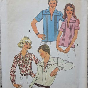 May include: Simplicity pattern 6957 with shirt designs. The image shows illustrations of various shirts, including a blue short-sleeve shirt, a pink short-sleeve shirt, a floral print shirt, and a white shirt with a lace-up front. The pattern size is medium, 96.5-101.6 cm.