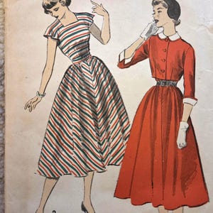 May include: Vintage sewing pattern titled "ADVANCE 5416" featuring illustrations of two dresses. One dress is red and the other is striped in red, green, and white. The pattern is size 16, with a bust of 33 inches, a waist of 27 inches, and hips of 36 inches.