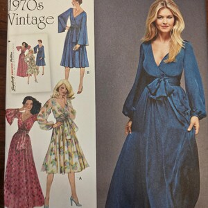 May include: A vintage sewing pattern featuring a woman in a long, flowing blue dress with a bow at the waist. The pattern includes illustrations of other dress designs from the 1970s, with the text "1970s Vintage" at the top.