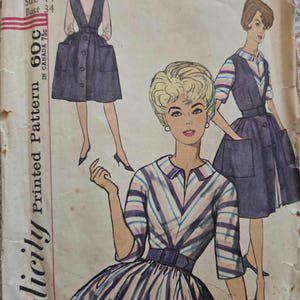 May include: Vintage Simplicity sewing pattern featuring illustrations of dresses. The pattern includes a dress with a striped bodice and skirt, and a button-down dress with pockets. The pattern is marked with the number 4092, size 14, and a bust size of 34 inches.