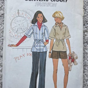 May include: Simplicity sewing pattern B077 featuring contemporary fashion designs. The pattern includes illustrations of two figures wearing different outfits. One figure wears a striped top and flared pants, while the other wears a short-sleeved shirt and shorts.