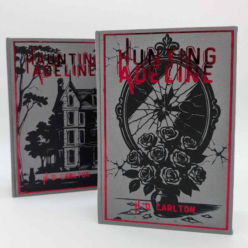 May include: Two hardcover books with the title "Hunting Adeline" in red foil lettering. One book features a haunted house illustration, the other a broken mirror with roses. Both have red borders and the author's name.