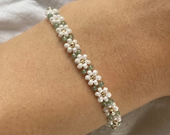 White floral beaded bracelet with green leaves optic