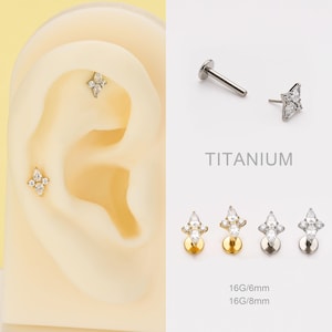 May include: Ear piercings with a floral design. The image shows a variety of titanium earrings with clear gemstones. The earrings are displayed on a model ear and separately. The text "TITANIUM" and "16G/6mm 16G/8mm" are also visible.