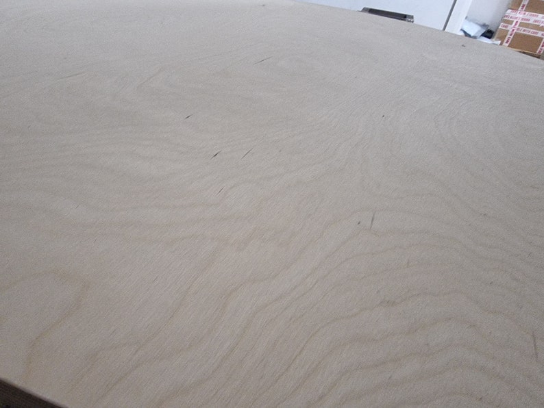 May include: A close-up of a light brown wood surface with a smooth, even texture. The surface has a subtle grain pattern.