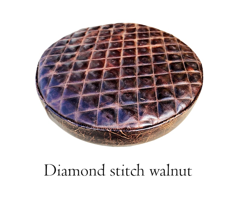 May include: A round brown leather seat cushion with diamond stitching. The cushion has a distressed look and is made of genuine leather.