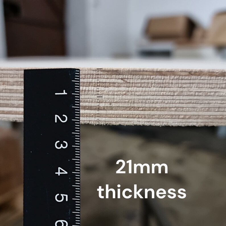May include: Close-up of a wooden board with a ruler measuring the thickness. The board is 21mm thick.