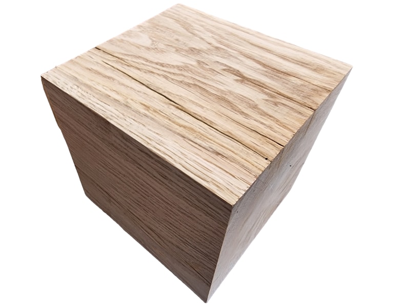 May include: A natural wood cube stool with a light brown finish and visible wood grain.