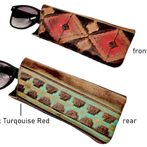 May include: A leather sunglasses case with a geometric pattern. The front of the case has a red and brown pattern, while the back has a turquoise and brown pattern. The text "Aztec Turquoise Red" is visible below the case.