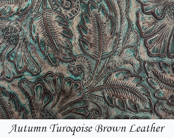 May include: Close-up of embossed leather with a floral pattern in shades of brown and turquoise.