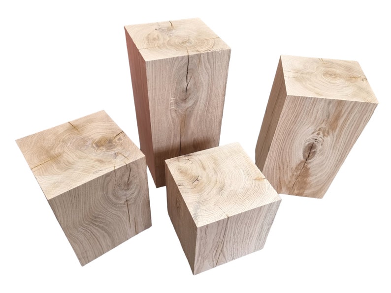 May include: Three wooden blocks of varying sizes, each with a natural wood grain finish. The blocks are arranged in a staggered formation, with the largest block in the back and the smallest block in the front.