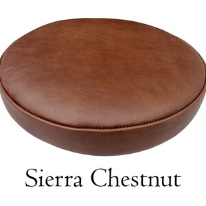 May include: A round brown leather seat cushion with a slightly rounded edge. The cushion is labeled "Sierra Chestnut".