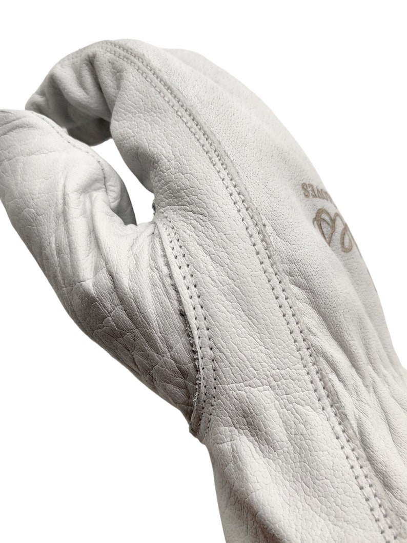 May include: White leather work gloves with reinforced stitching and the word "Gloves" embroidered on the back of the hand.