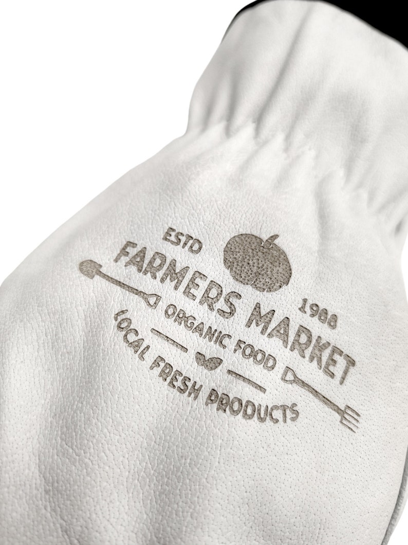 May include: White leather bag with a brown logo that says "Estd Farmers Market 1968 Organic Food Local Fresh Products". The logo also includes a tomato, a shovel, and a fork.