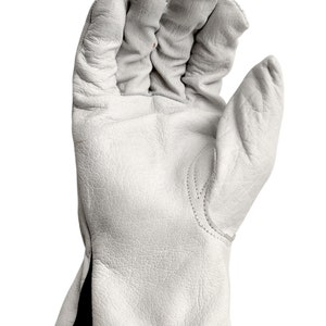 May include: White leather work gloves with a black cuff. The gloves have a textured surface and are designed for protection and durability.