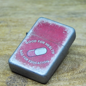 Flip Top Lighter in a case with a Akira pill - good for health bad for education