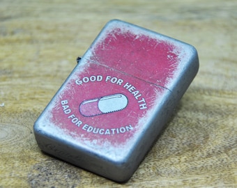 Flip Top Lighter in a case with a Akira pill - good for health bad for education