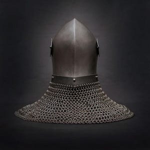 Op de afbeelding: Een middeleeuwse helm met een puntige bovenkant en een mali&euml;nkolder nekbescherming. De helm is gemaakt van metaal en heeft een donkere, matte afwerking. De mali&euml;nkolder is gemaakt van kleine, in elkaar grijpende metalen ringen.