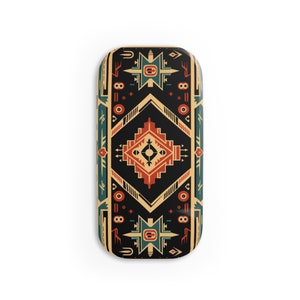 May include: Rectangular case with a Southwestern-inspired design. The case features a black background with geometric patterns in red, teal, and beige. The design includes diamond and star shapes, creating a tribal aesthetic.