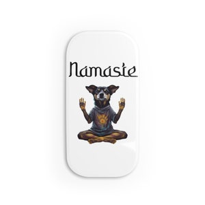 May include: White rectangular magnet with the word "Namaste" in black script. The magnet features a dog in a yoga pose, wearing a hoodie with a colorful graphic. The dog is in a seated position with its hands raised.