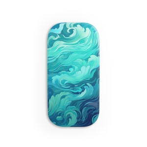 May include: A rectangular tray with rounded corners, featuring a swirling ocean wave design in shades of teal, turquoise, and deep blue. The artwork evokes a sense of movement and fluidity, resembling a stylized seascape.