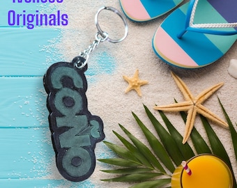 Resin keychain alluding to the Puerto Rican word "COñO"