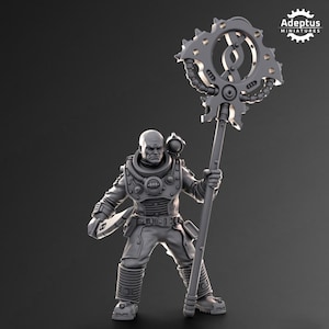 May include: A gray plastic miniature of a futuristic character holding a large, detailed, gear-shaped weapon. The character is wearing a helmet and a suit with a belt and pouches. The weapon has a long handle and a circular head with gears and pipes.