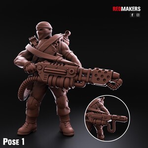 May include: A brown plastic miniature figure of a soldier wearing a black mask and holding a large, detailed, futuristic weapon. The figure is posed in a dynamic stance, with the weapon pointed forward. The figure is labelled "Pose 1".