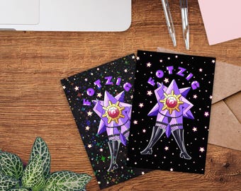 May include: Two greeting cards with a purple star-shaped figure wearing thigh-high boots. The cards have the word "FOTZIG" in purple. One card has a black background with white stars, and the other has a black background with iridescent glitter.