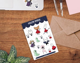 May include: A sticker sheet featuring various cartoon characters from the game Hollow Knight. The stickers include characters in different poses and colors, with the text "Hollow Knight" at the top. Some stickers are on a laptop.