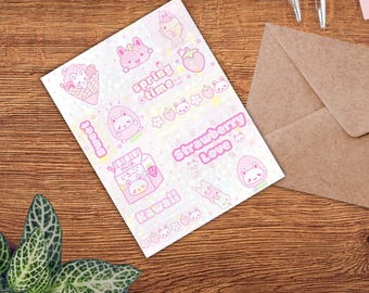 May include: A sheet of pink and white stickers with kawaii illustrations of bunnies, strawberries, and ice cream cones. Text includes "Spring Time", "Strawberry Love", and "Kawaii". The stickers are on a wooden surface with a brown envelope and a plant.