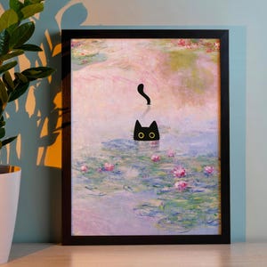 May include: Framed art print featuring a whimsical design of a black cat in a pond with lily pads and pink flowers. The artwork is set against a soft, impressionistic background, framed in a black border.