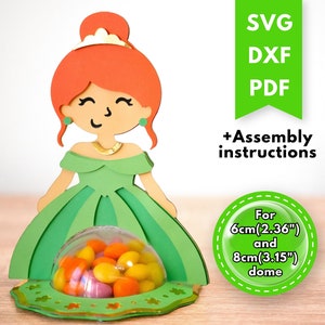 May include: A green and gold princess party favor box with a clear dome for candy. The box is designed for a 2.36 inch or 3.15 inch dome. SVG, DXF, and PDF files are included with assembly instructions.
