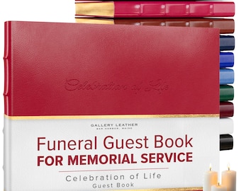 May include: A red leather-bound funeral guest book with gold-edged pages. The cover features the embossed text "Celebration of Life" and a white band with the text "Funeral Guest Book FOR MEMORIAL SERVICE". A stack of similar books in various colors is visible.