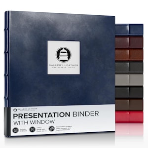 May include: A navy blue three-ring presentation binder with a square window on the front cover. The cover features a logo with a lighthouse and the text GALLERY LEATHER BAR HARBOR, MAINE. A stack of binders in various colors is visible to the right.