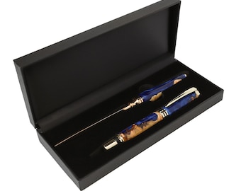 May include: A blue and tan marbled resin pen and a matching letter opener with gold-tone metal accents, presented inside a rectangular black hinged gift box with a black velvet-lined interior for secure storage and display of the writing set.