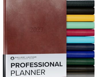 May include: A brown leather 2027 professional planner by Gallery Leather with a white paper band featuring the text Gallery Leather Bar Harbor Maine Professional Planner, displayed alongside a vertical stack of planners in various colors.