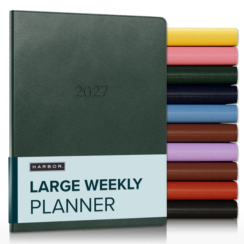 May include: A dark green 2027 large weekly planner with a textured cover and a light blue paper band featuring the text HARBOR LARGE WEEKLY PLANNER. A vertical stack of planners in yellow, pink, dark green, navy, blue, brown, lilac, brown, orange, and black.