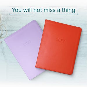 May include: Two rectangular planners, one in light purple and one in bright orange, each embossed with the year 2027 on the front cover. The text "You will not miss a thing" is printed in dark teal above the planners on a light wood background.