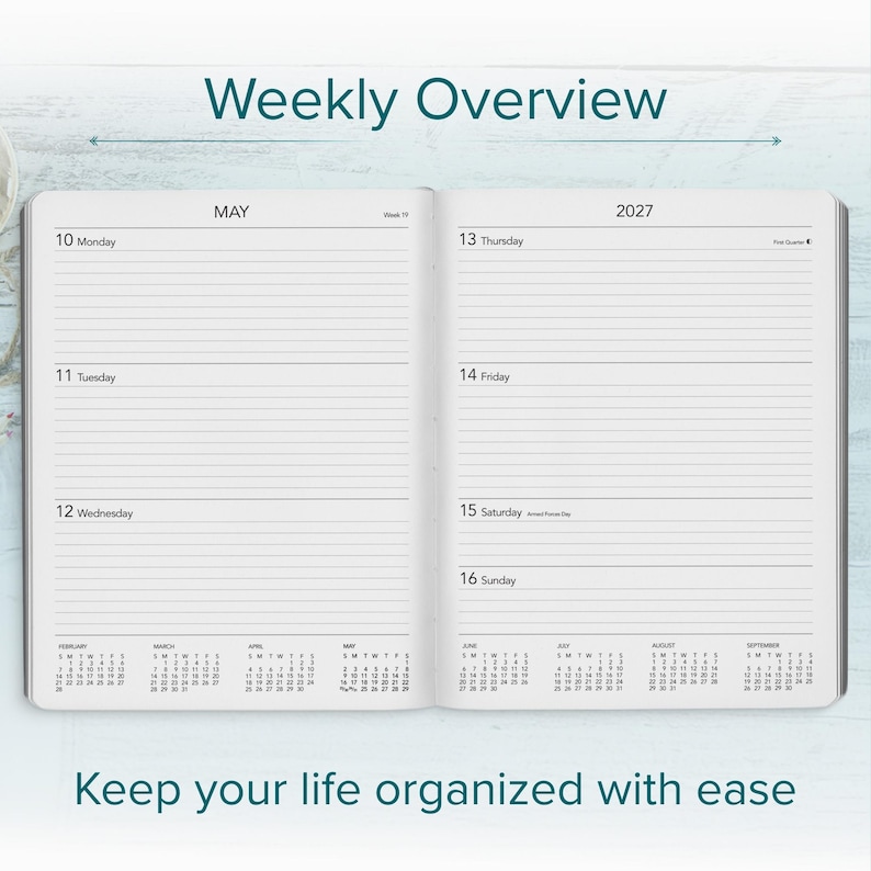 May include: An open weekly planner showing a May 2027 calendar spread. The left page lists Monday through Wednesday, and the right page lists Thursday through Sunday. Small monthly calendars for February through September are printed at the bottom.