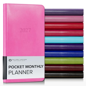 May include: A bright pink 2027 pocket monthly planner by Gallery Leather with a white paper band featuring the text Gallery Leather Bar Harbor Maine Pocket Monthly Planner, stacked next to a vertical row of planners in various solid colors.
