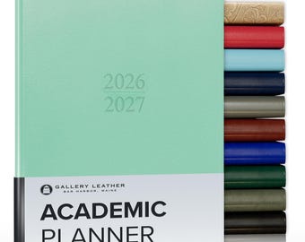 May include: A mint green academic planner with the years 2026 and 2027 embossed on the cover. A white band at the bottom displays the text Gallery Leather Bar Harbor, Maine Academic Planner. A stack of planners in various colors is visible.