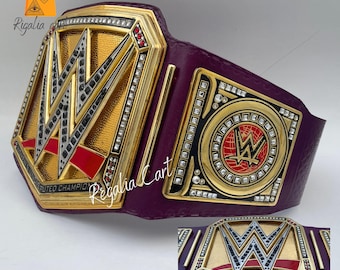 May include: A gold and purple championship belt with the WWE logo. The belt features a large central plate with the WWE logo and smaller plates with the words "Women's Undisputed Champion". The belt is made of leather and metal.
