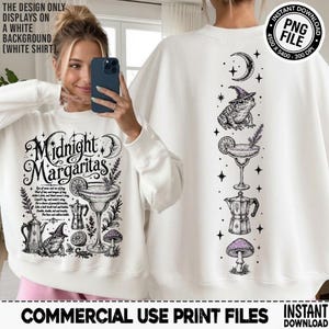 May include: A white sweatshirt featuring a black graphic print with the text Midnight Margaritas, a frog wearing a witch hat, a margarita glass, a moka pot, and a mushroom. The design includes celestial stars and moon motifs.