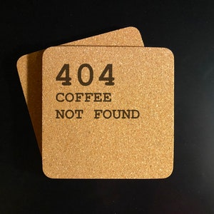 May include: Two brown cork coasters with the text "404 COFFEE NOT FOUND" printed on them.