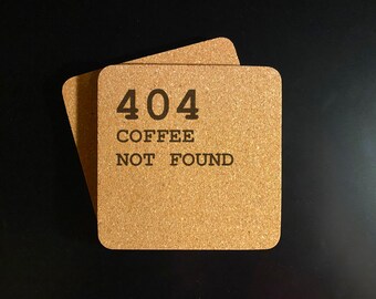 May include: Two brown cork coasters with the text "404 COFFEE NOT FOUND" printed on them.