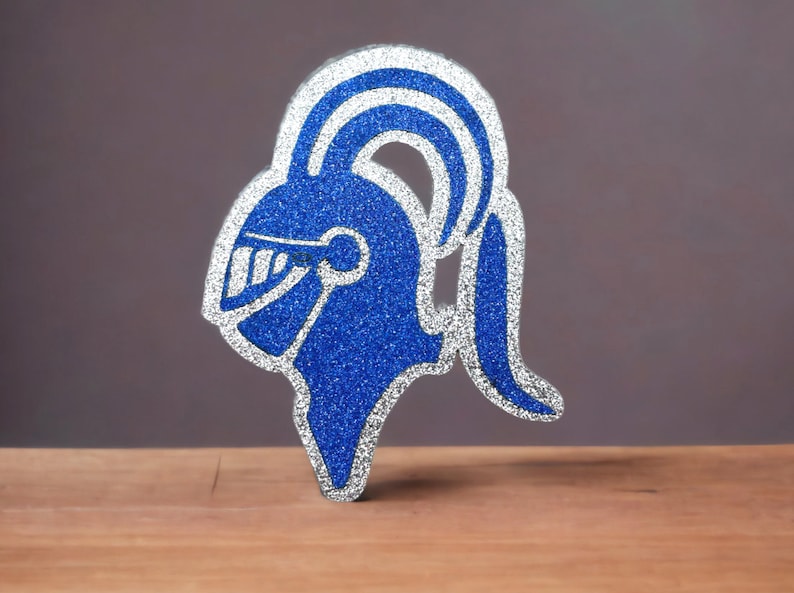 May include: A blue and silver glitter knight helmet cutout. The helmet has a plume on top and a face shield.