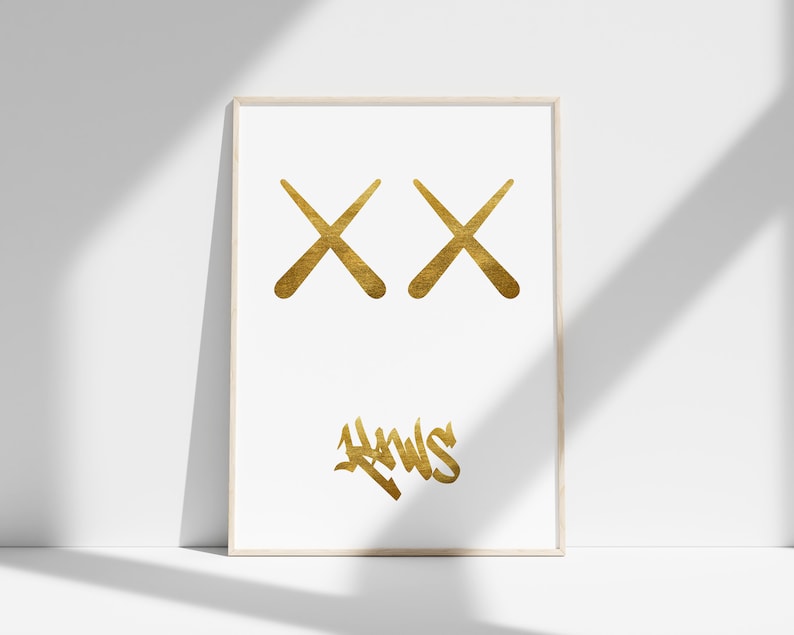 May include: Gold framed print featuring two gold X's and the word "HWS" in gold script.